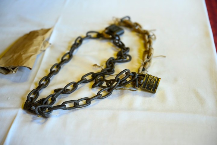 A chain and padlock on top of a white sheet