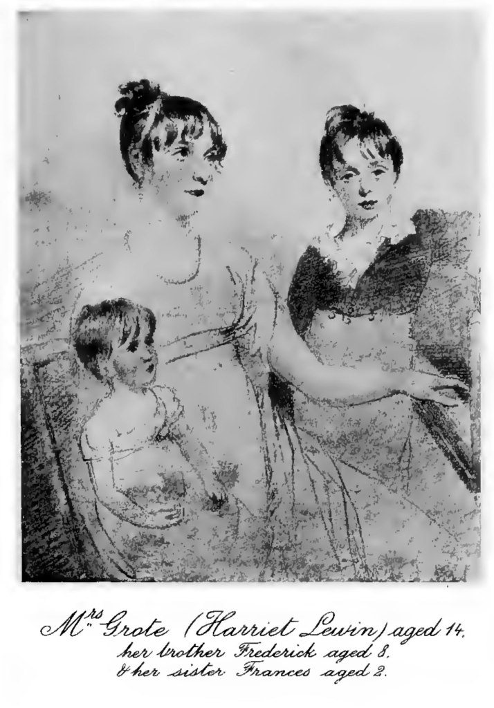 a black and white painting of three young siblings. Underneath the image is the caption Mrs Grote (Harriet Lewin) aged 14, her brother Fredericl aged 8, and her sister Frances aged 2. The eldest is sitting on a chair with the youngest sibling on her lap, and is playing a piano on the right of the picture with one hand. Next to the eldest sibling standing up is the middle child, just shorter than his sister sitting down.