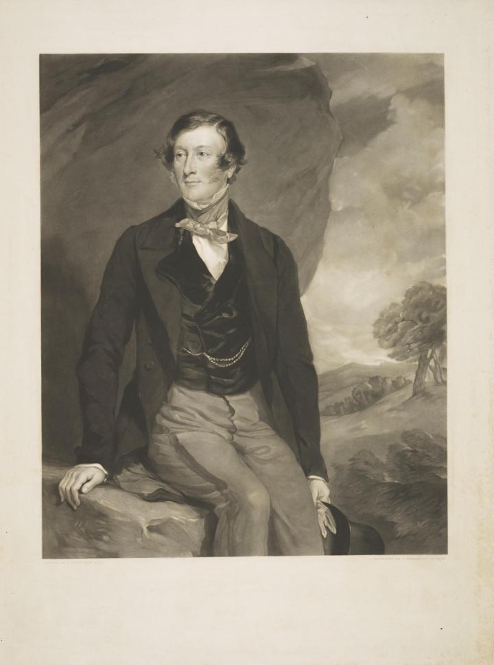 A knee-length portrait of Henry Charles Sturt. On black and white mezzotint on fading yellow paper, the portrait is set in the landscape, with a tree on a small hill to the right of the picture. Sturt is sat on a large rock, which also rises up behind him. He is wearing light trousers with a darker stripe down their side, a black waistcoat with a watch chain set in his right pocket, a black suit jacket, a white shirt and a light necktie. He is clean shaven, with short sideburns and medium length parted combed dark hair. 