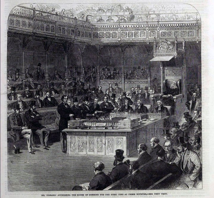 A sketch of the House of Commons in session. The caption at the bottom reads: Mr Disraeli addressing the House of Commons for the first time as Prime Minister. In the sketch, Mr Disraeli is standing at the table of the house next to the despatch box talking to a full House of Commons.