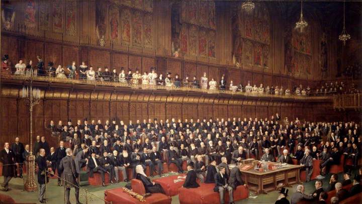 A coloured painting of the House of Lords during the Home Rule Debate, 1893. The chamber is full of peers, with the Marquess of Salisbury addressing the chamber from the despatch box. The gallery above the benches is also full of female onlookers. 