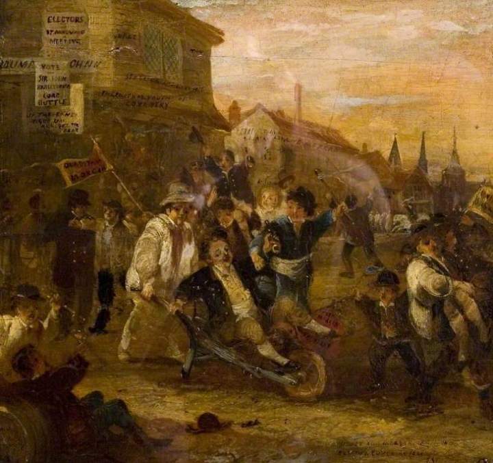 An oil painting of an election riot in Coventry (1861), where in the middle of a road, a rauvous crows with banners and flags are rioting. In the middle a man is being wheeled around in a wheelbarrow.